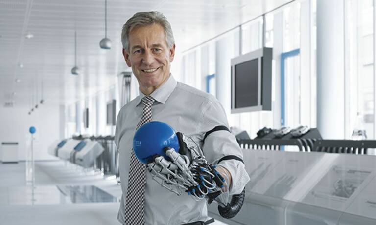 Dr. Eberhard Veit, président du directoire de Festo, avec le concept ExoHand issu du Bionic Learning Network. © Festo
